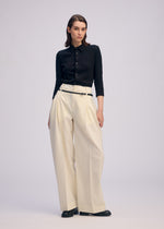 A model wears the Issey Miyake BELTED WOOL PANTS prêt à porter.