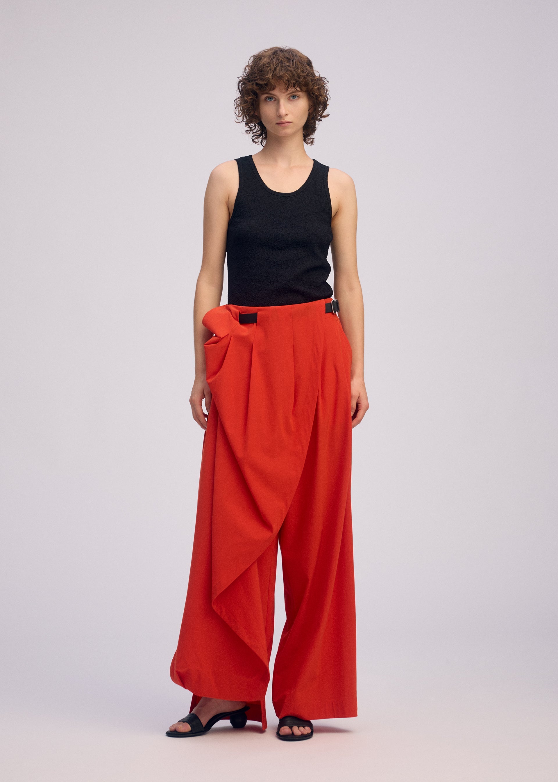 A model wears the Issey Miyake LOOPED pants.