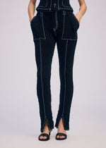 A model wears the ISSEY MIYAKE WAVELET ENSEMBLE pants.