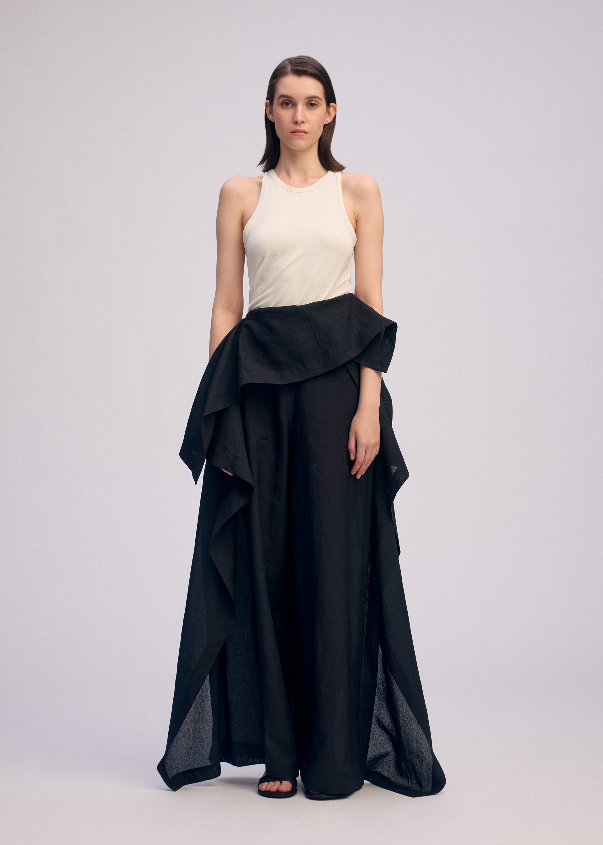 A model wears the ISSEY MIYAKE ALL SQUARES pants.