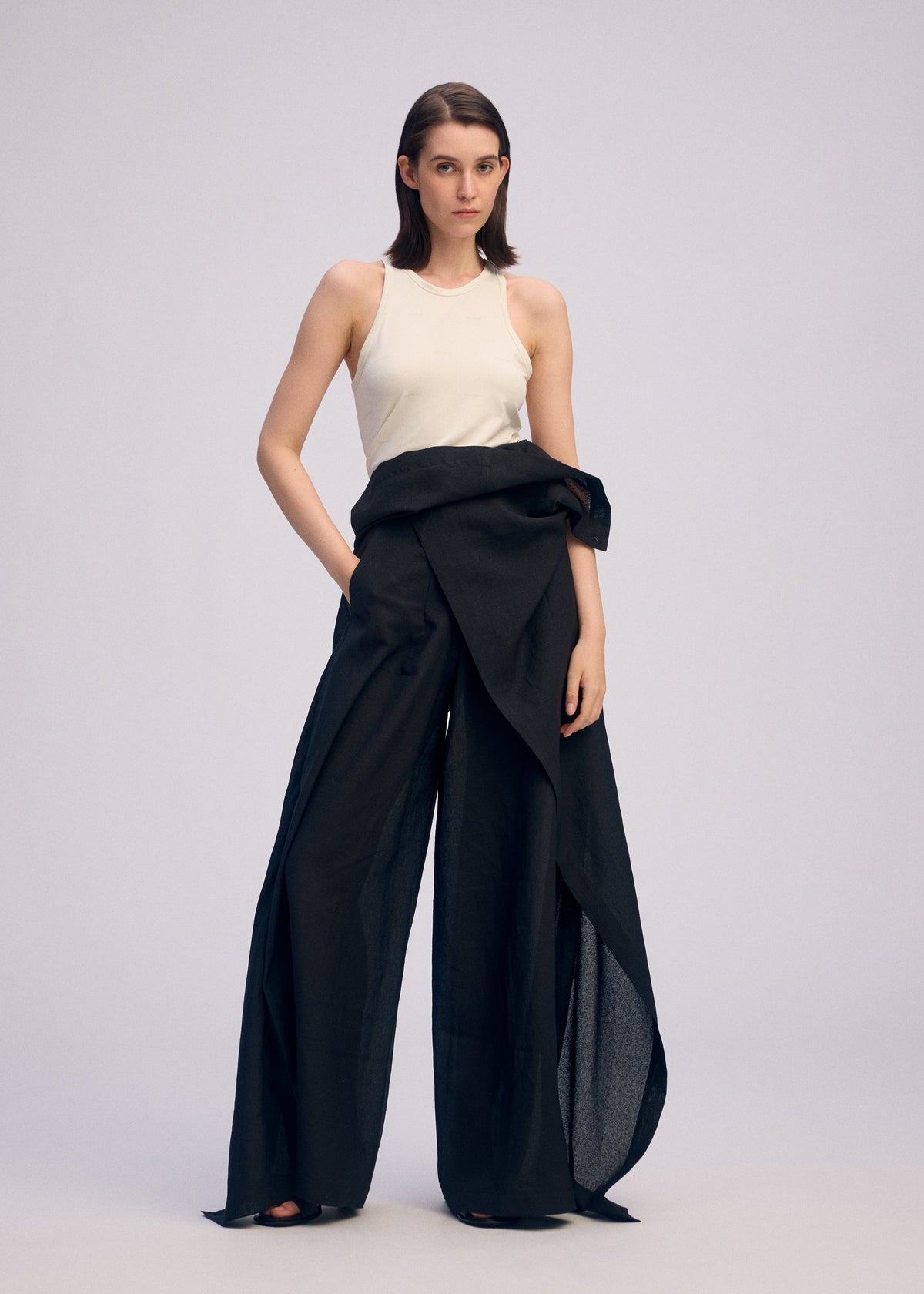 A model wears the ISSEY MIYAKE ALL SQUARES pants.