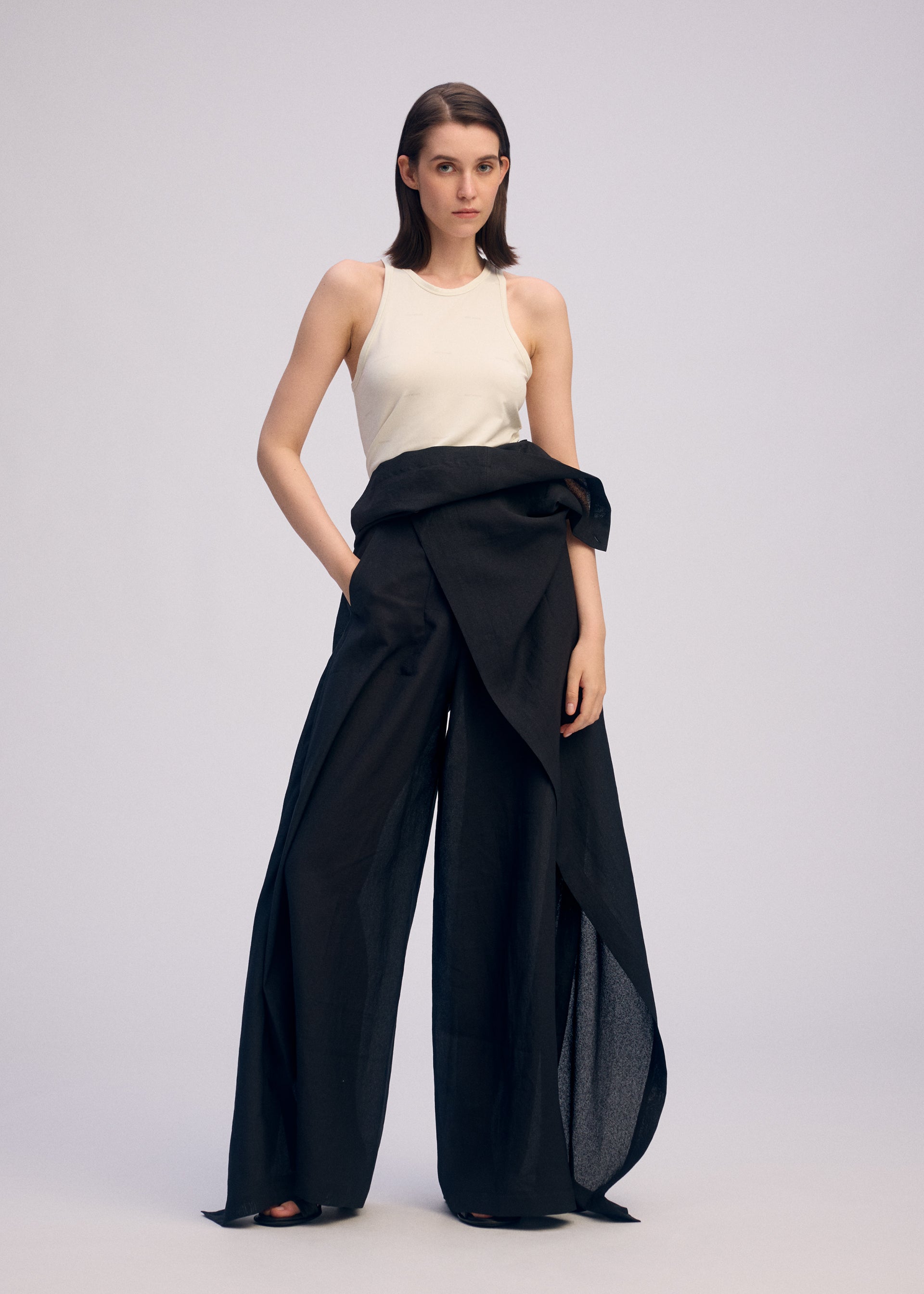 A model wears the ISSEY MIYAKE ALL SQUARES pants.