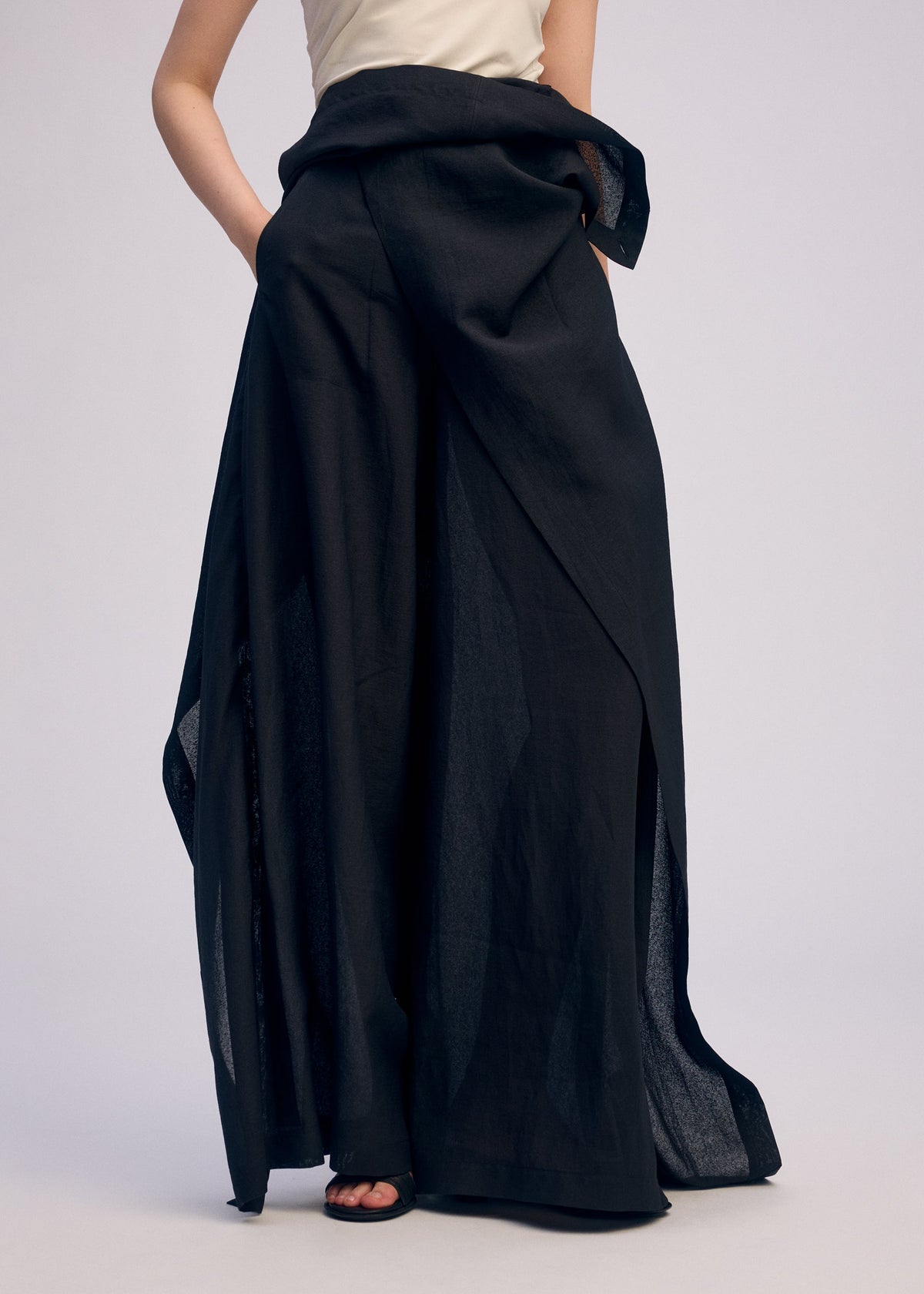 A model wears the ISSEY MIYAKE ALL SQUARES pants.