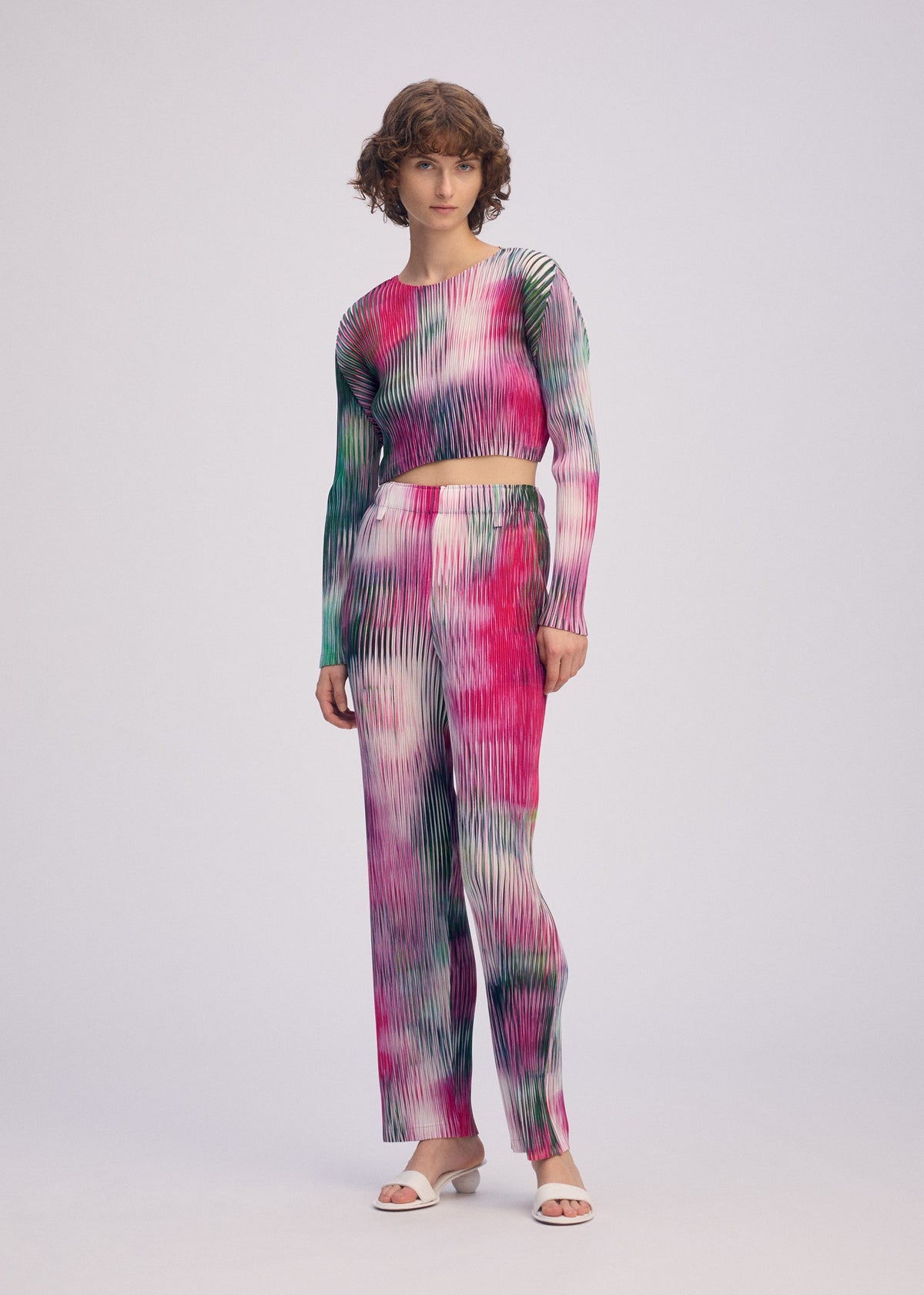 A model wears the ISSEY MIYAKE OBSCURE PLEATS prêt à porter.