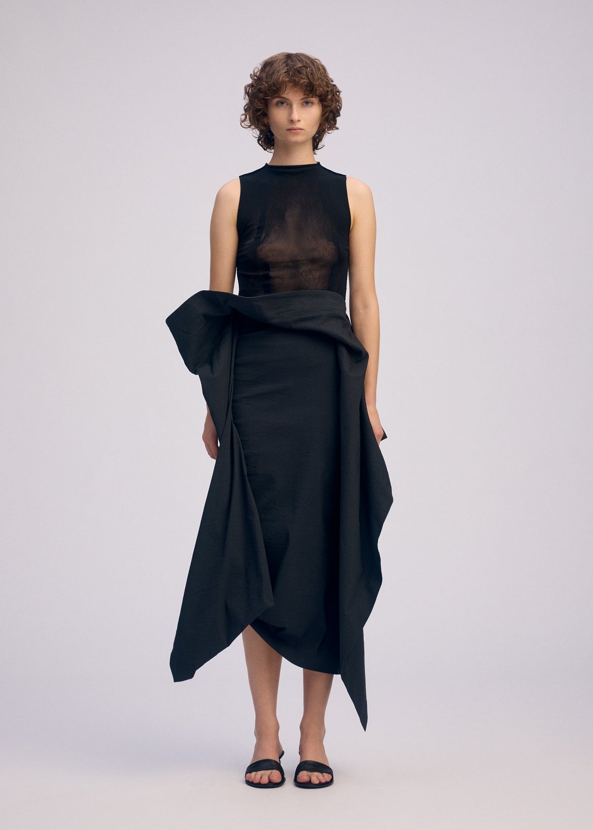 A model wears the ISSEY MIYAKE CONCEALED concealed-skirt-white.