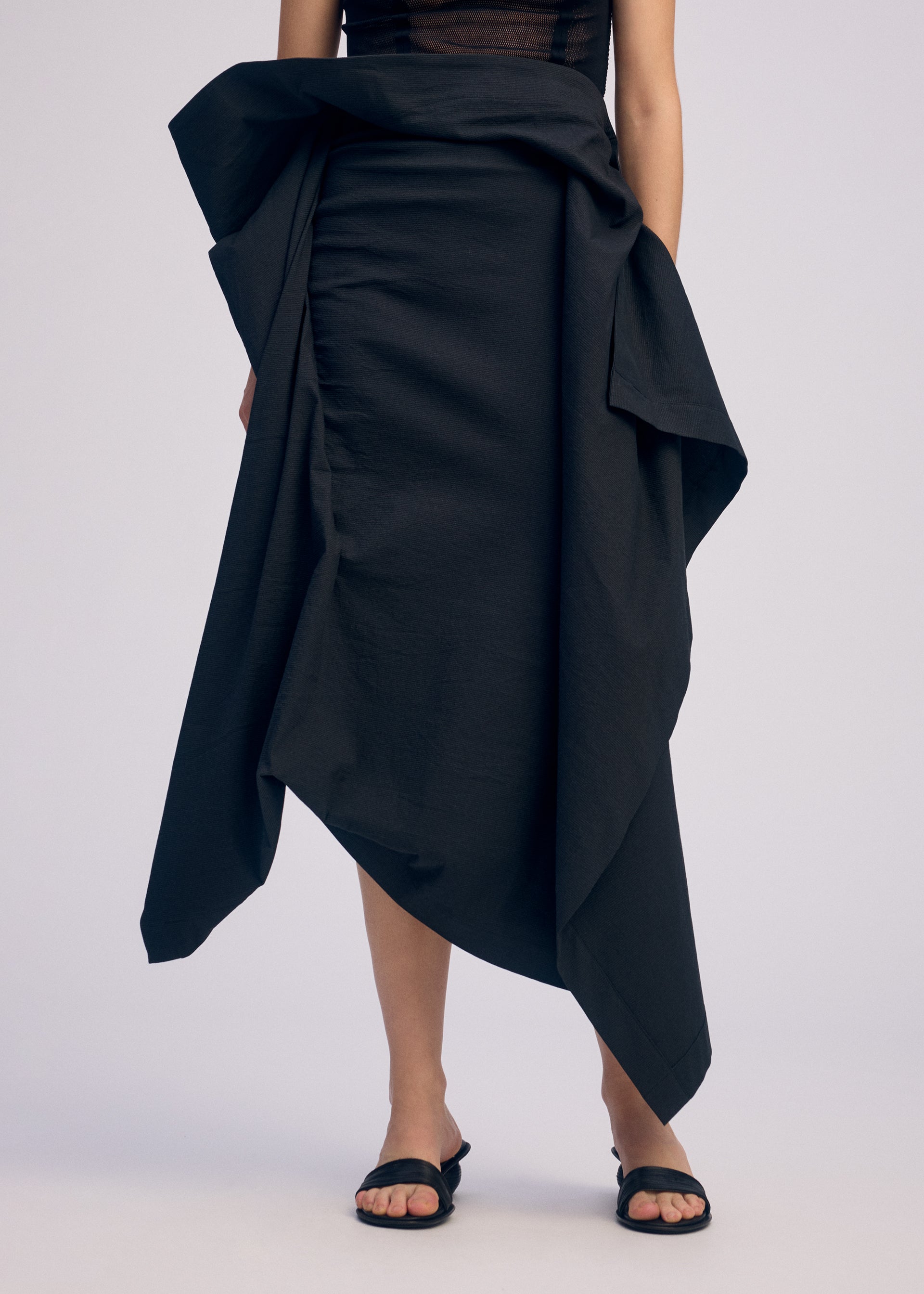 A model wears the ISSEY MIYAKE CONCEALED skirt.