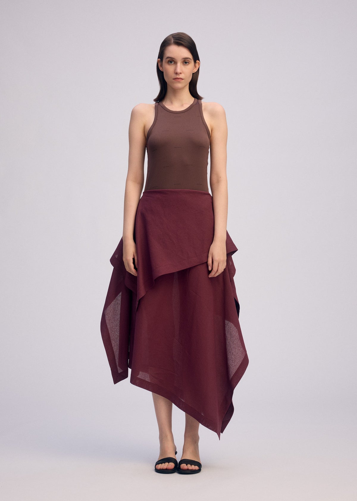 A model wears the ISSEY MIYAKE ALL SQUARES skirt.