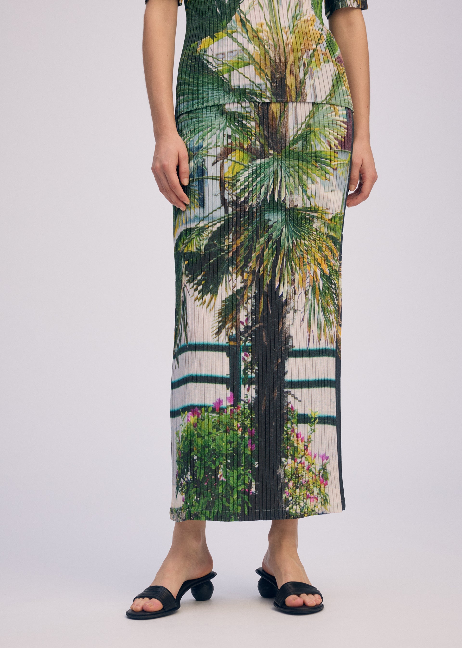 A model wears the Issey Miyake URBAN JUNGLE PLEATS skirt.