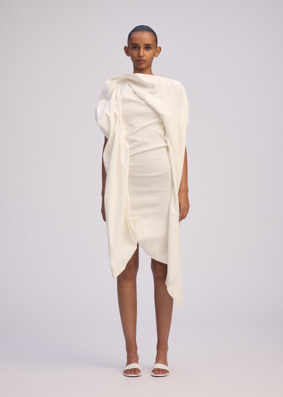A model wears the ISSEY MIYAKE CONCEALED concealed-dress-black.