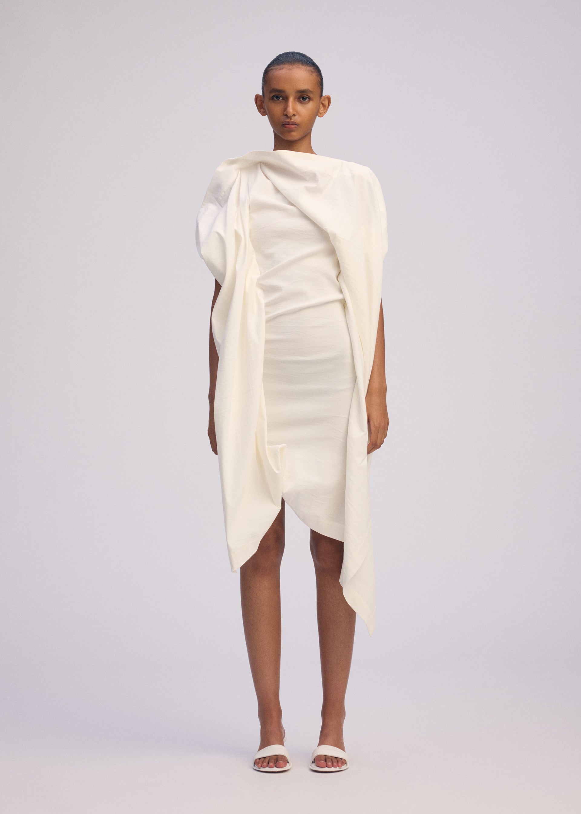 A model wears the ISSEY MIYAKE CONCEALED concealed-dress-black.