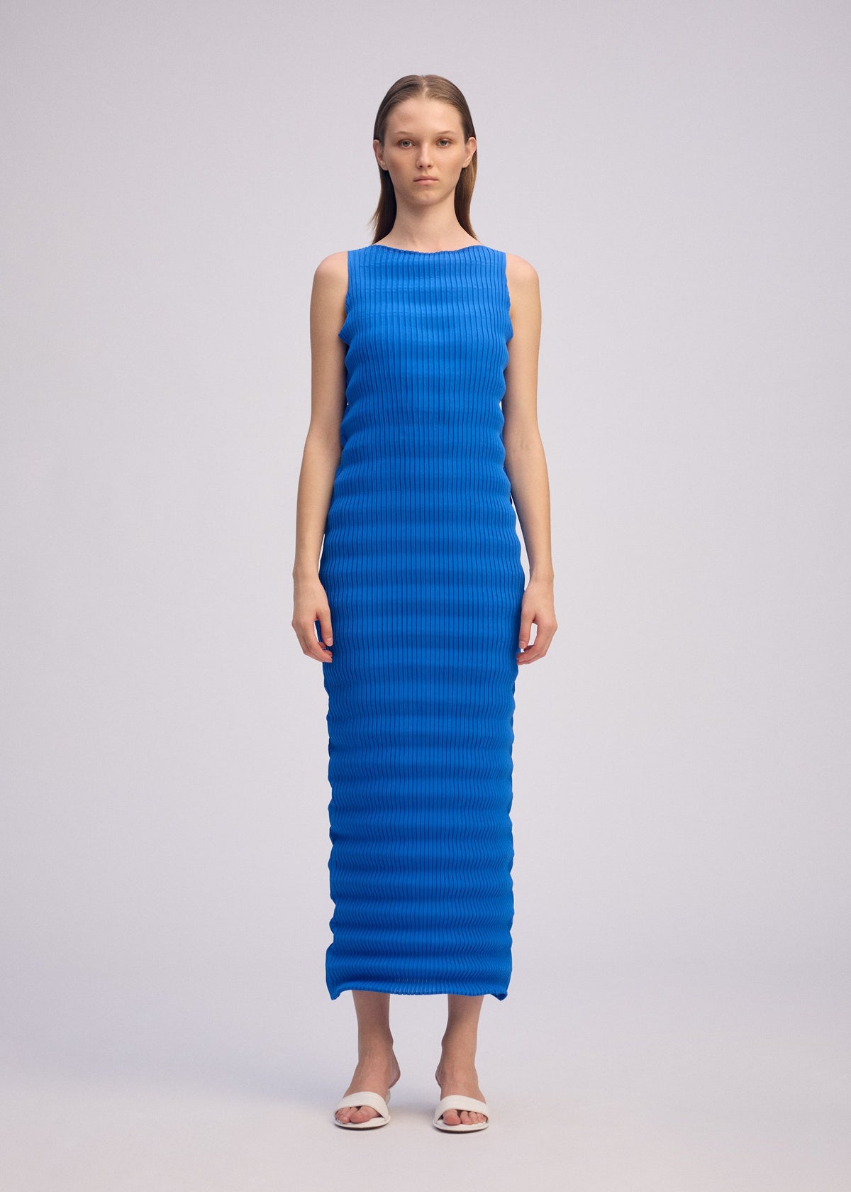 A model wears the ISSEY MIYAKE SPRING PLEATS spring-pleats-dress-starling-blue-1.