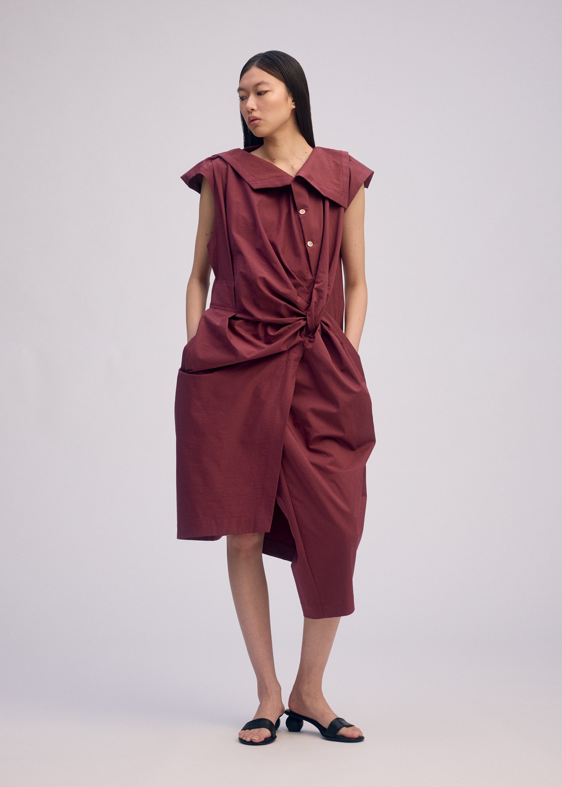 A model wears the ISSEY MIYAKE TWISTED DRAPE jumpsuit.