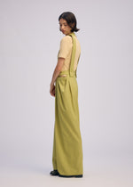A model wears the Issey Miyake BELTED WOOL PANTS prêt à porter.