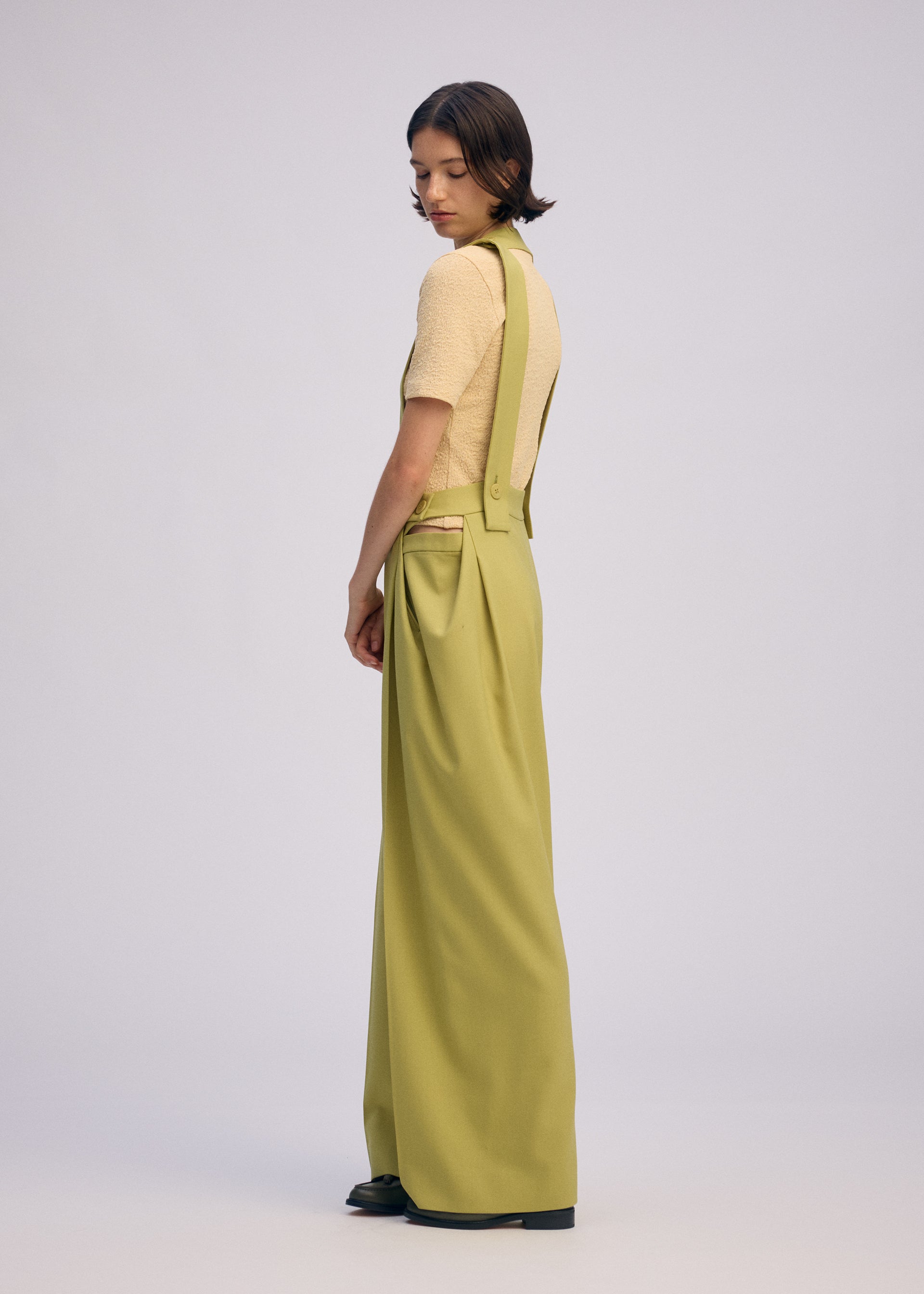 A model wears the Issey Miyake BELTED WOOL PANTS prêt à porter.