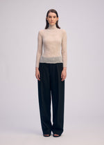 A model wears the ISSEY MIYAKE CHIFFON TWIST 3 shirt.