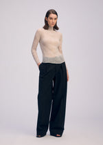 A model wears the ISSEY MIYAKE CHIFFON TWIST 3 shirt.
