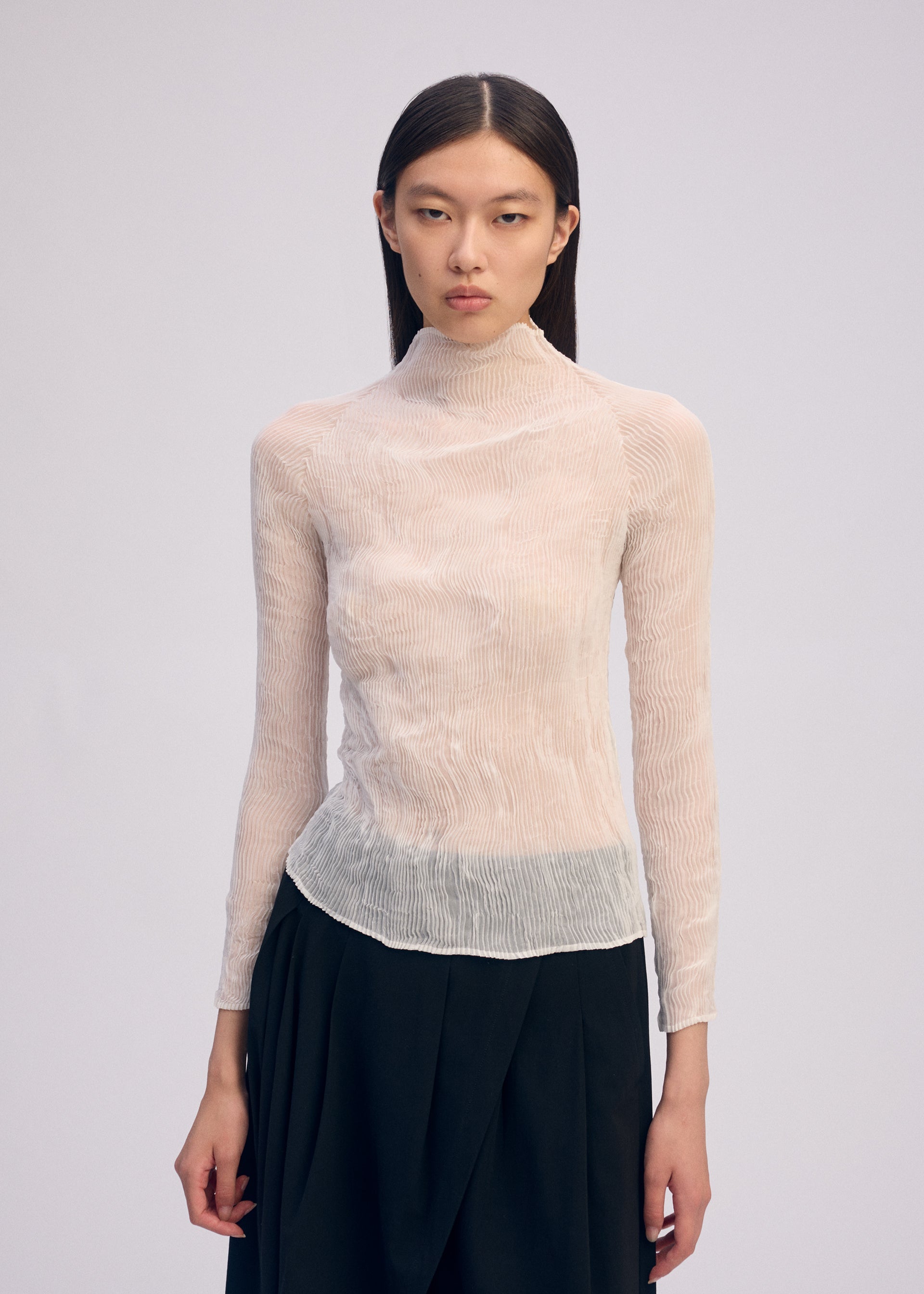 A model wears the Issey Miyake CHIFFON TWIST BKWT 66 shirt.