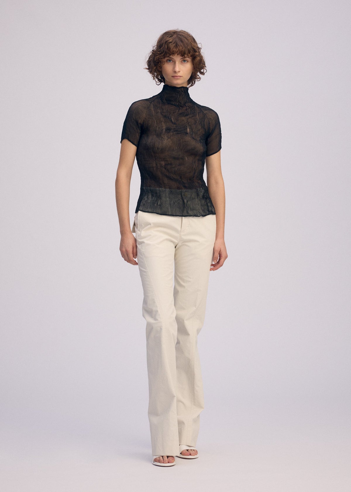 A model wears the Issey Miyake CHIFFON TWIST BKWT 66 shirt.