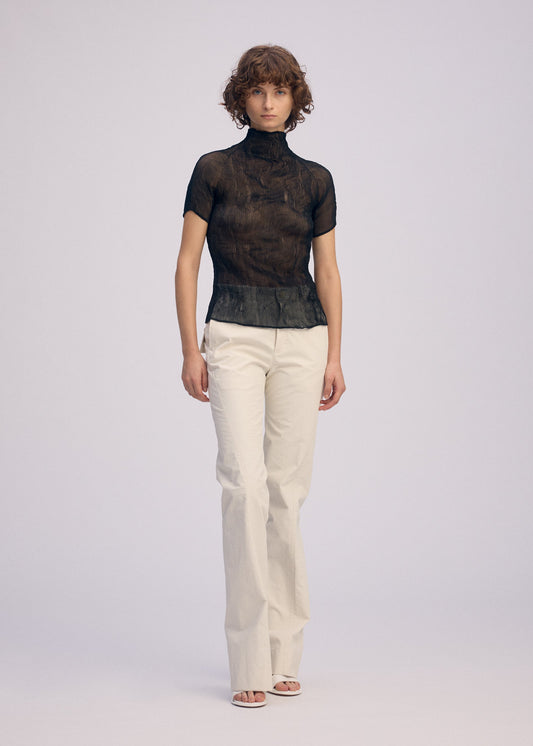 A model wears the Issey Miyake CHIFFON TWIST BKWT 66 shirt.