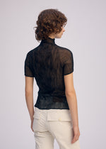 A model wears the Issey Miyake CHIFFON TWIST BKWT 66 shirt.