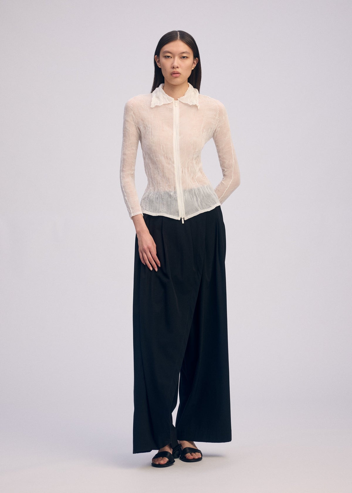 A model wears the Issey Miyake CHIFFON TWIST BKWT 66 shirt.