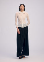 A model wears the Issey Miyake CHIFFON TWIST BKWT 66 shirt.