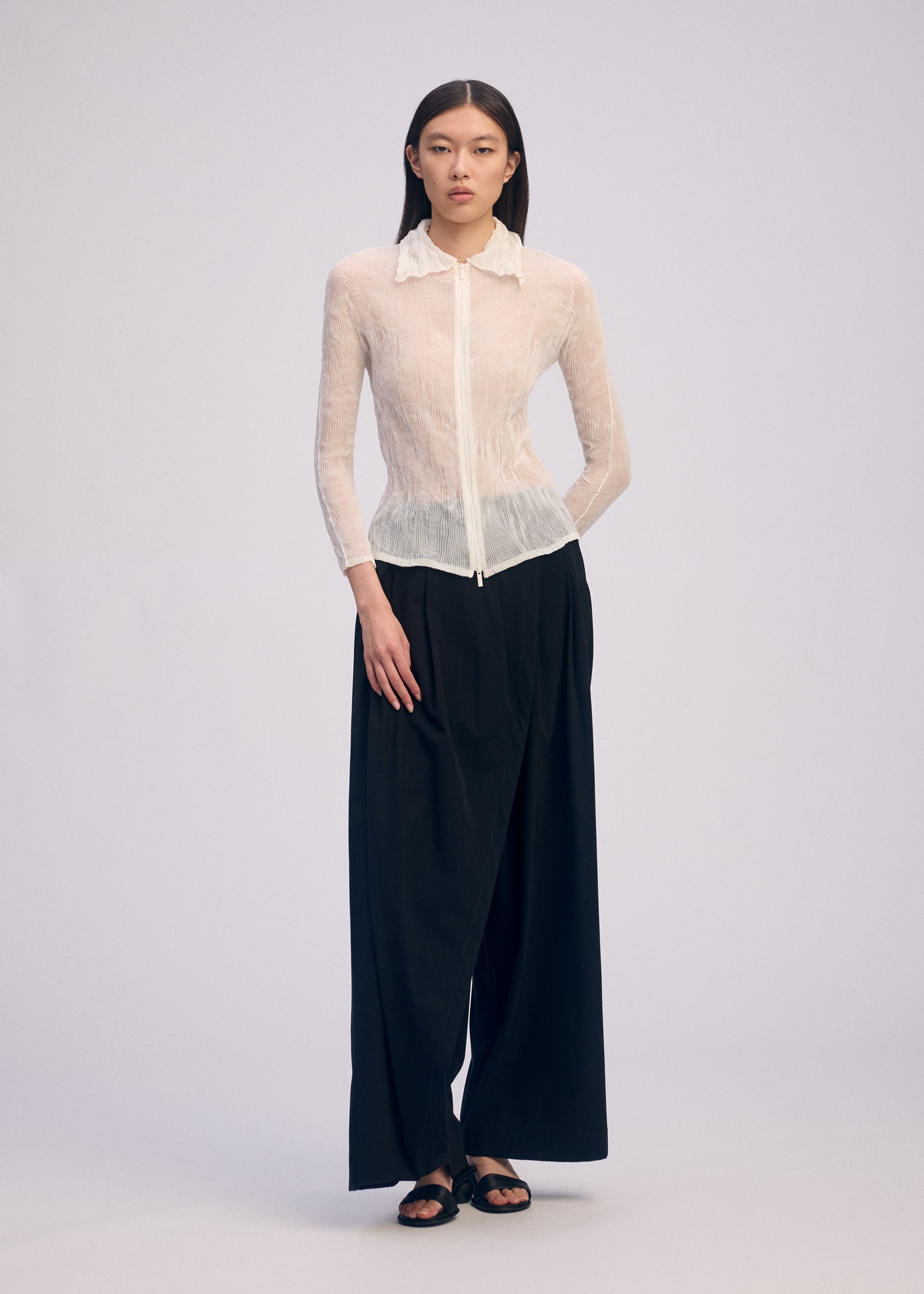 A model wears the Issey Miyake CHIFFON TWIST BKWT 66 shirt.
