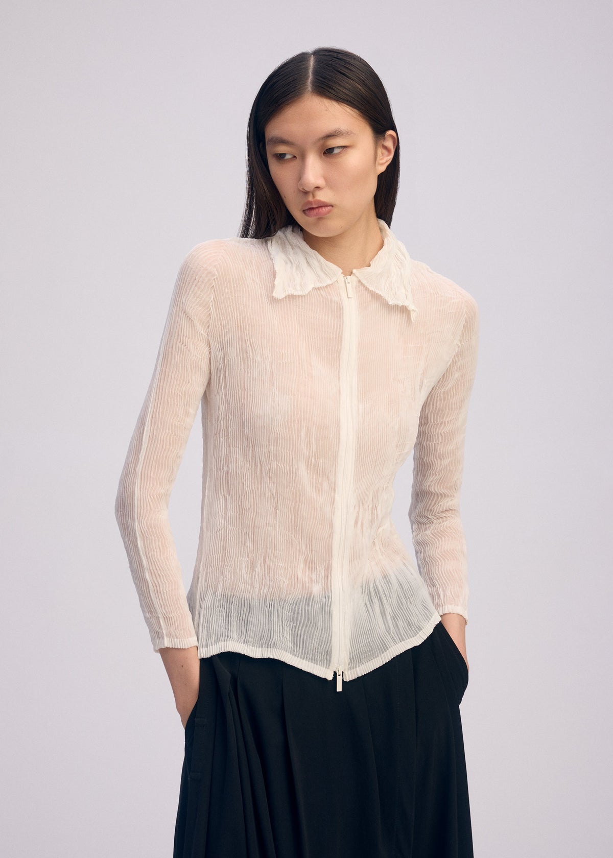 A model wears the Issey Miyake CHIFFON TWIST BKWT 66 shirt.