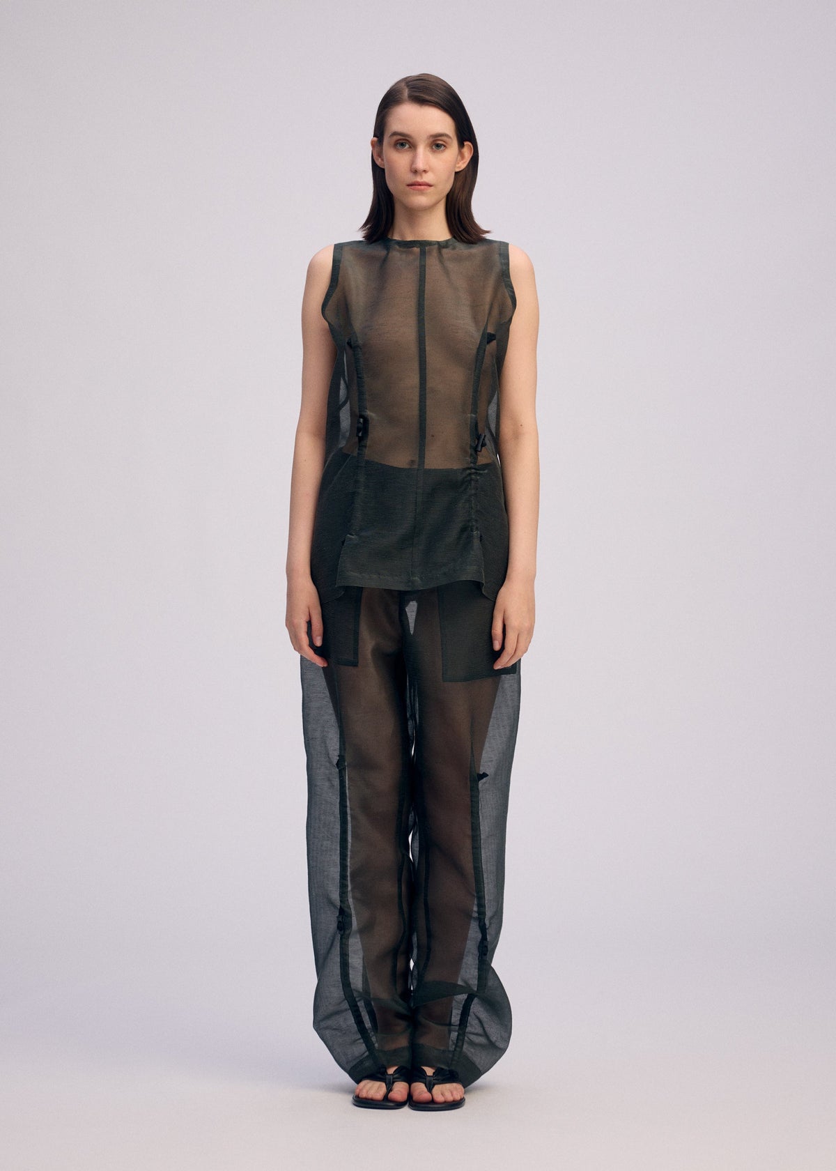A model wears the Issey Miyake DRAW TO FORM shirt.
