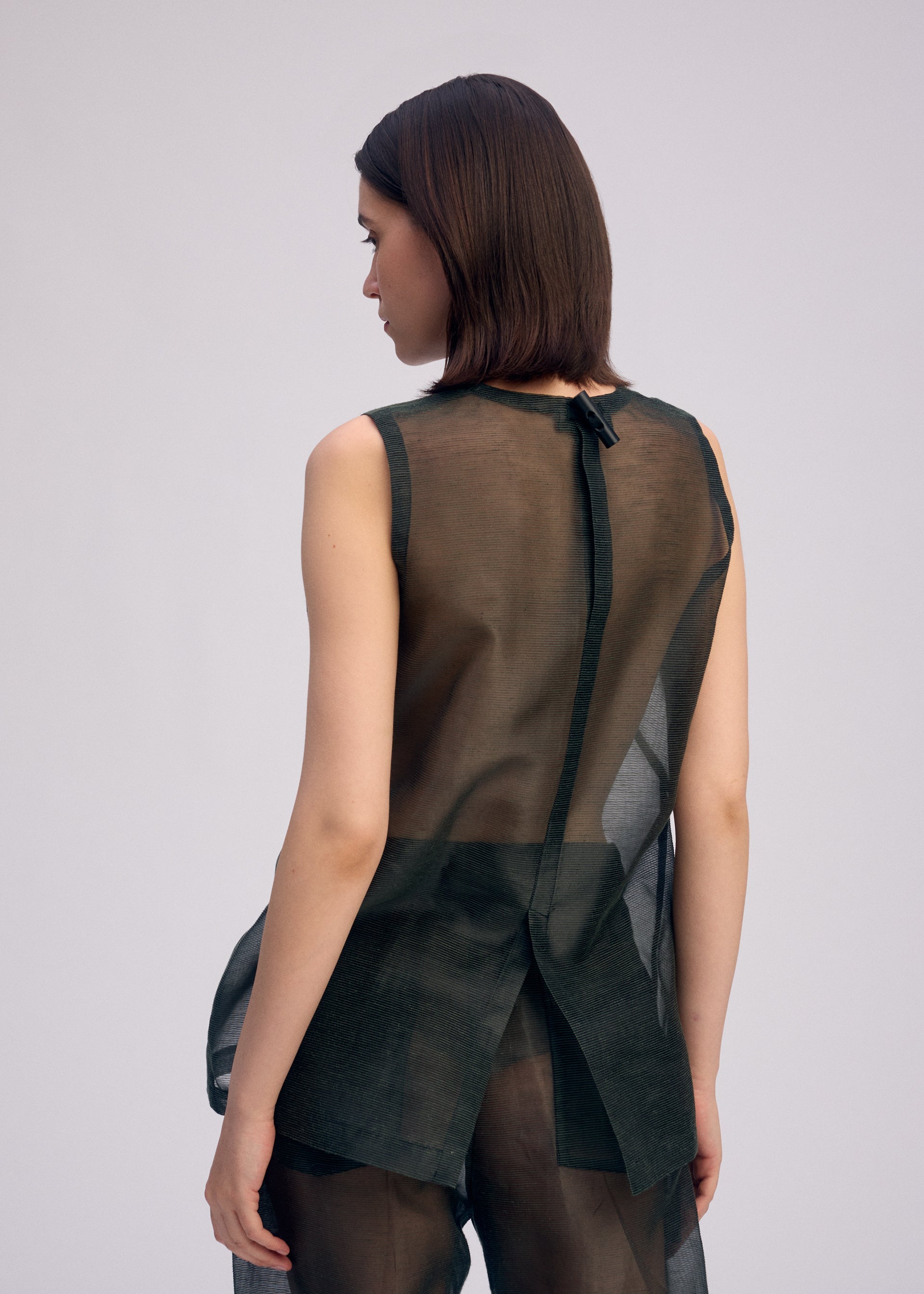 A model wears the Issey Miyake DRAW TO FORM shirt.