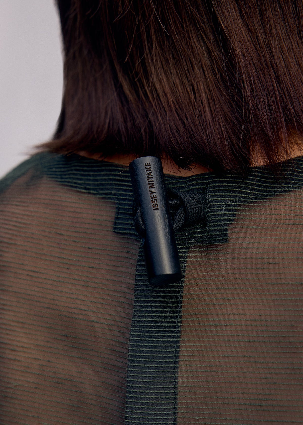 A model wears the Issey Miyake DRAW TO FORM shirt.