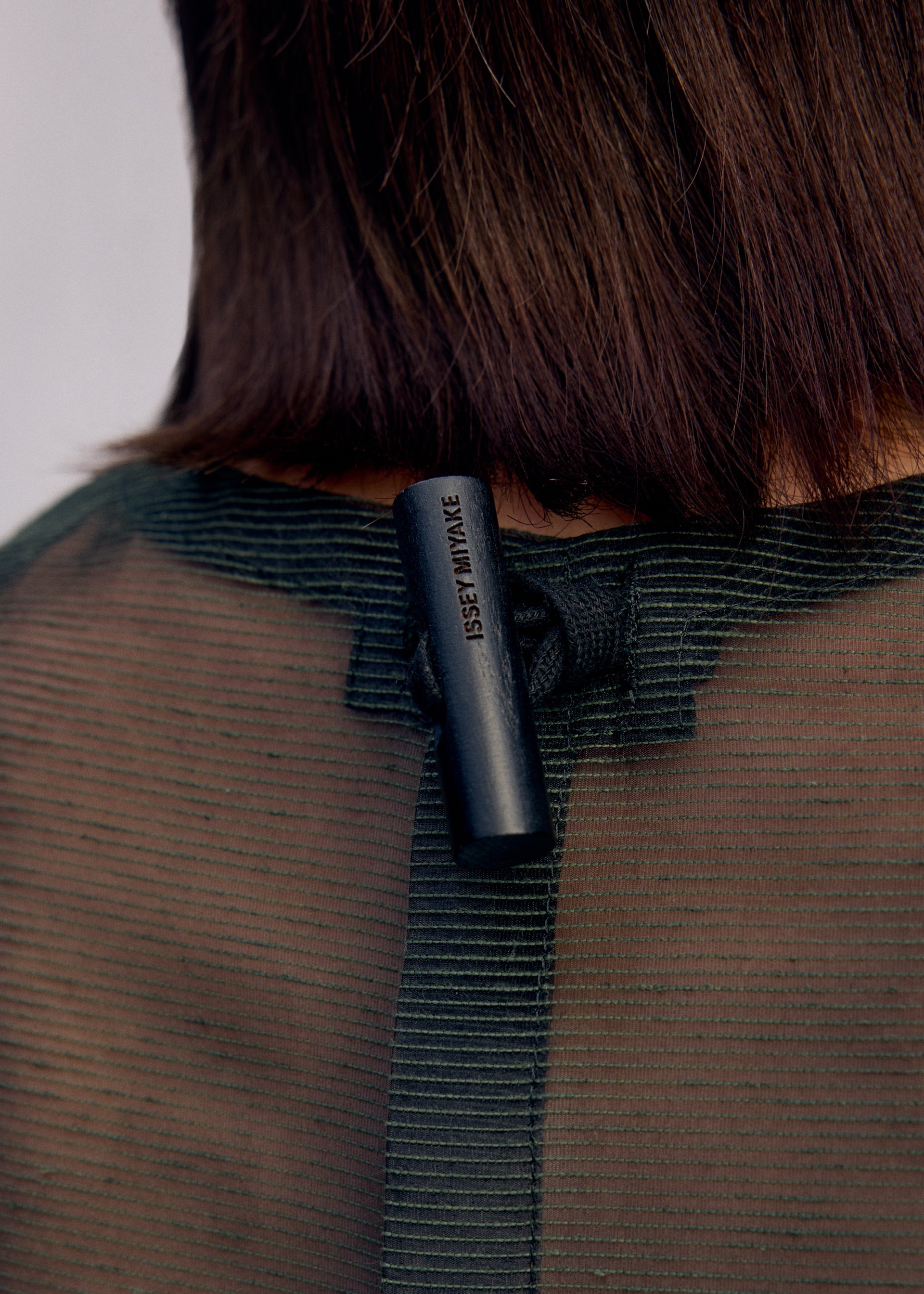 A model wears the Issey Miyake DRAW TO FORM shirt.