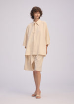 A model wears the Issey Miyake LOOPED shirt.
