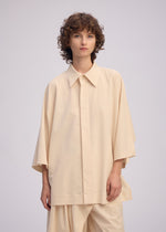 A model wears the Issey Miyake LOOPED shirt.