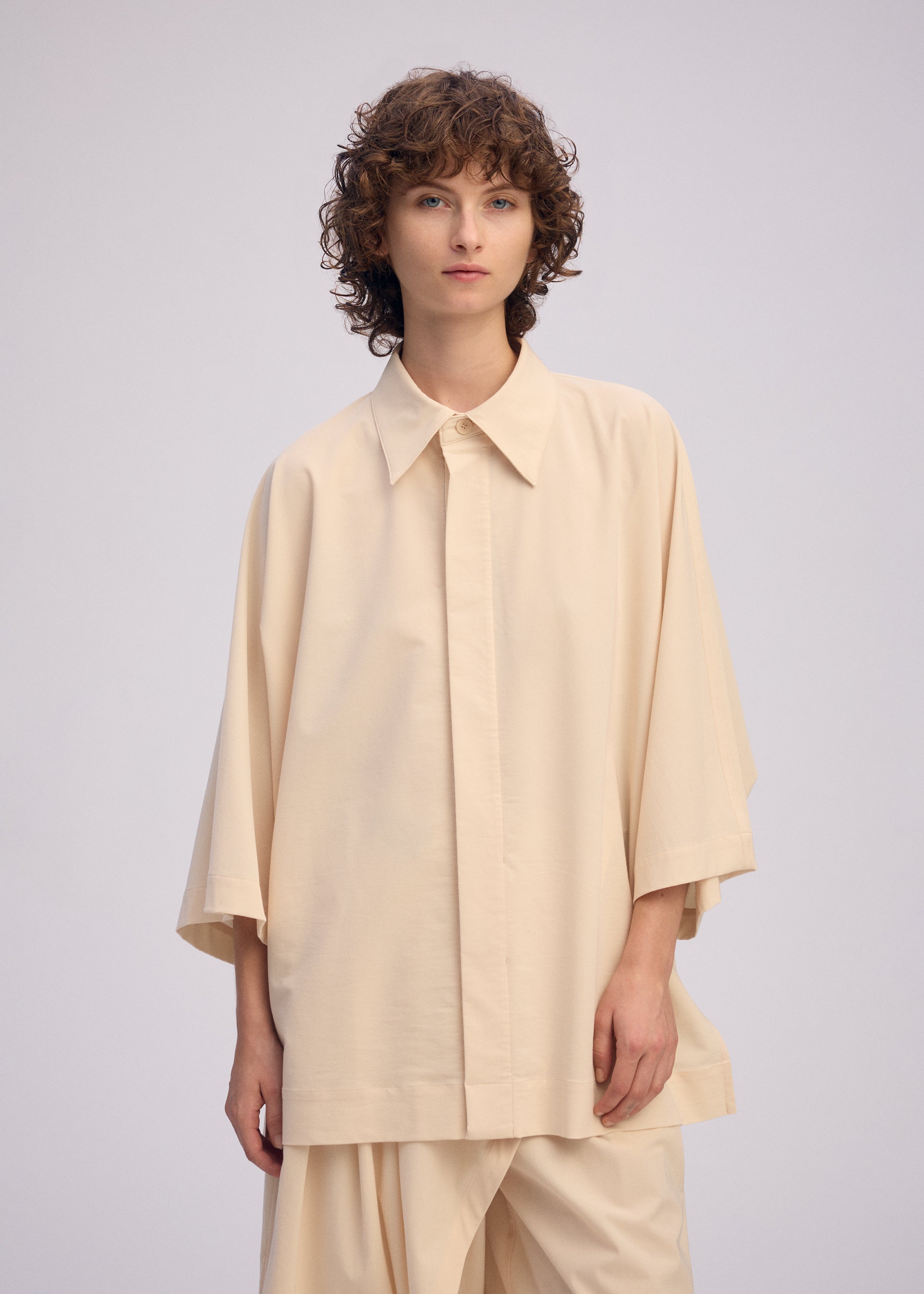 A model wears the Issey Miyake LOOPED shirt.
