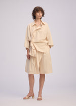A model wears the Issey Miyake LOOPED shirt.