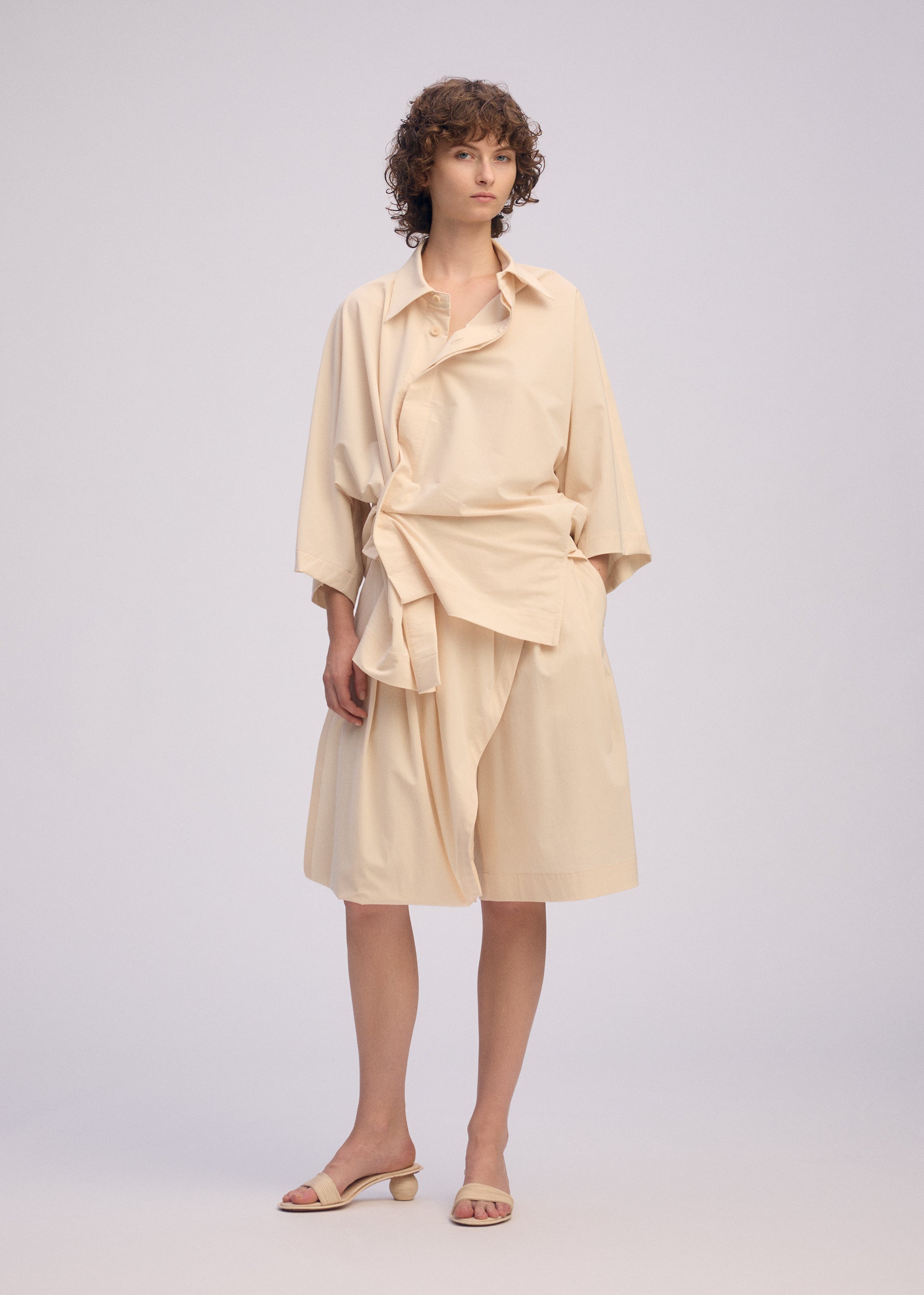 A model wears the Issey Miyake LOOPED shirt.