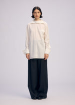A model wears the ISSEY MIYAKE ODD SHIRT 2 prêt à porter.