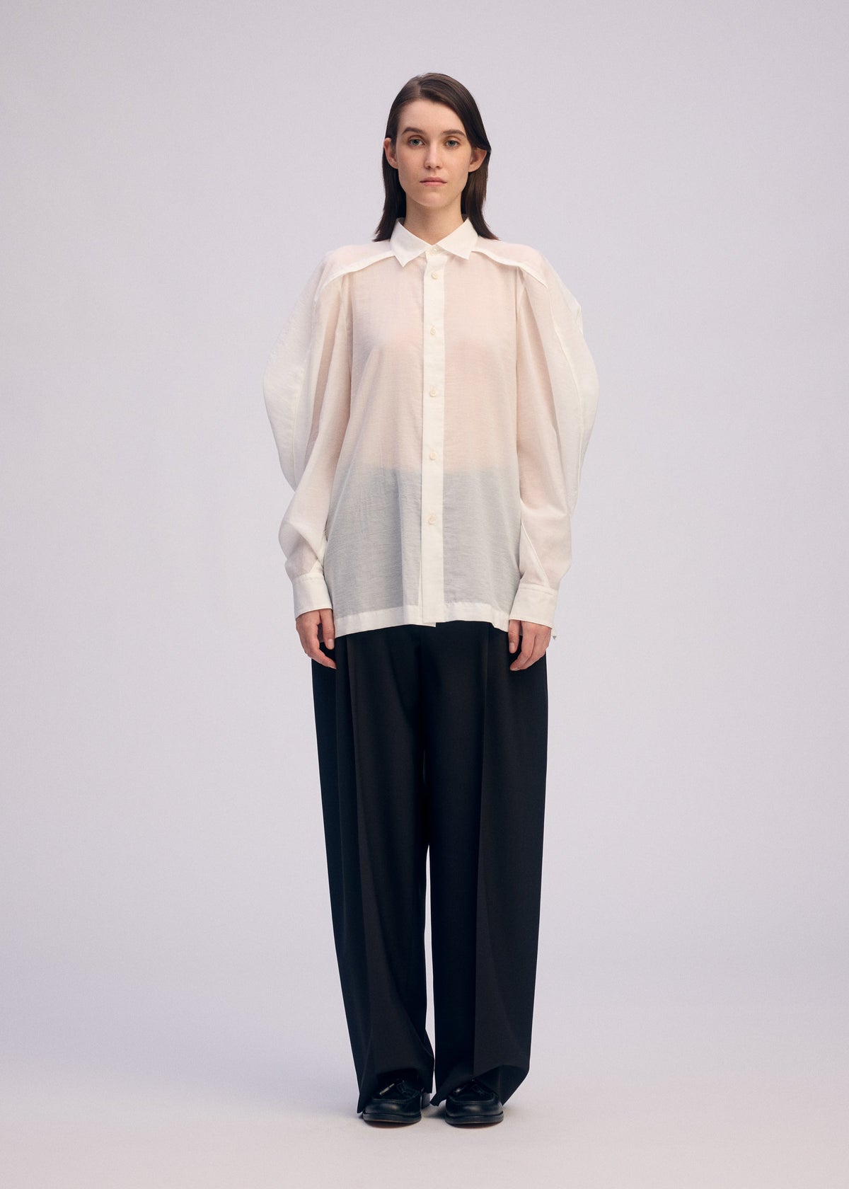 A model wears the Issey Miyake R SHIRT SHEER prêt à porter.