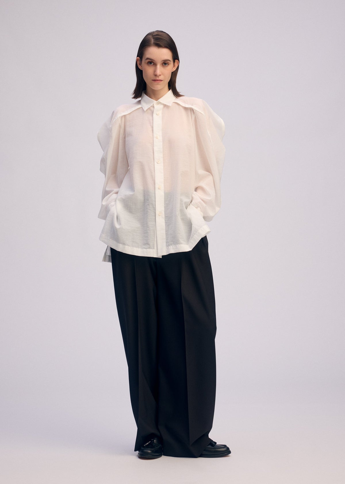 A model wears the Issey Miyake R SHIRT SHEER prêt à porter.
