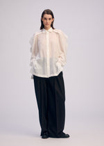 A model wears the Issey Miyake R SHIRT SHEER prêt à porter.