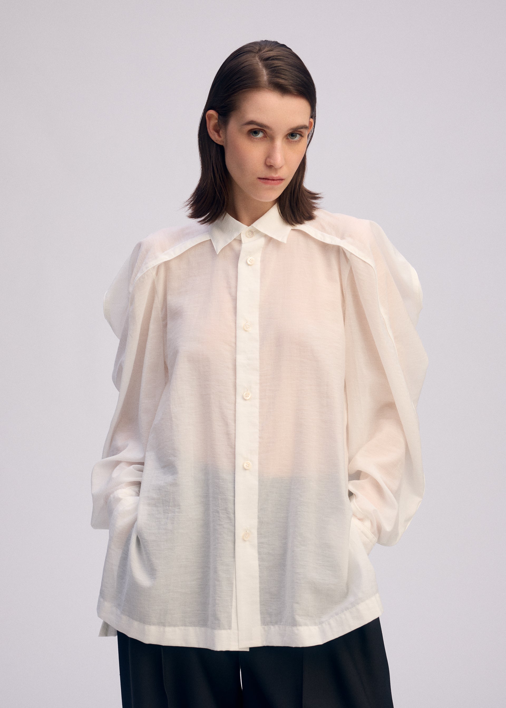 A model wears the Issey Miyake R SHIRT SHEER prêt à porter.