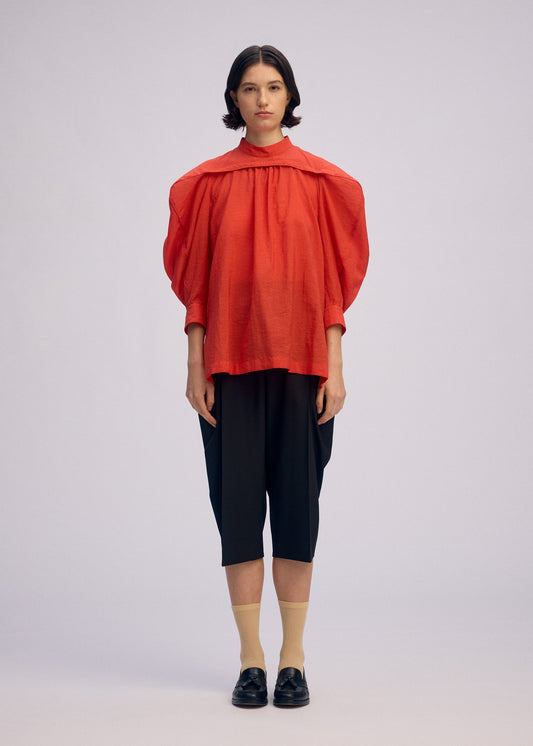 A model wears the Issey Miyake R SHIRT SHEER prêt à porter.