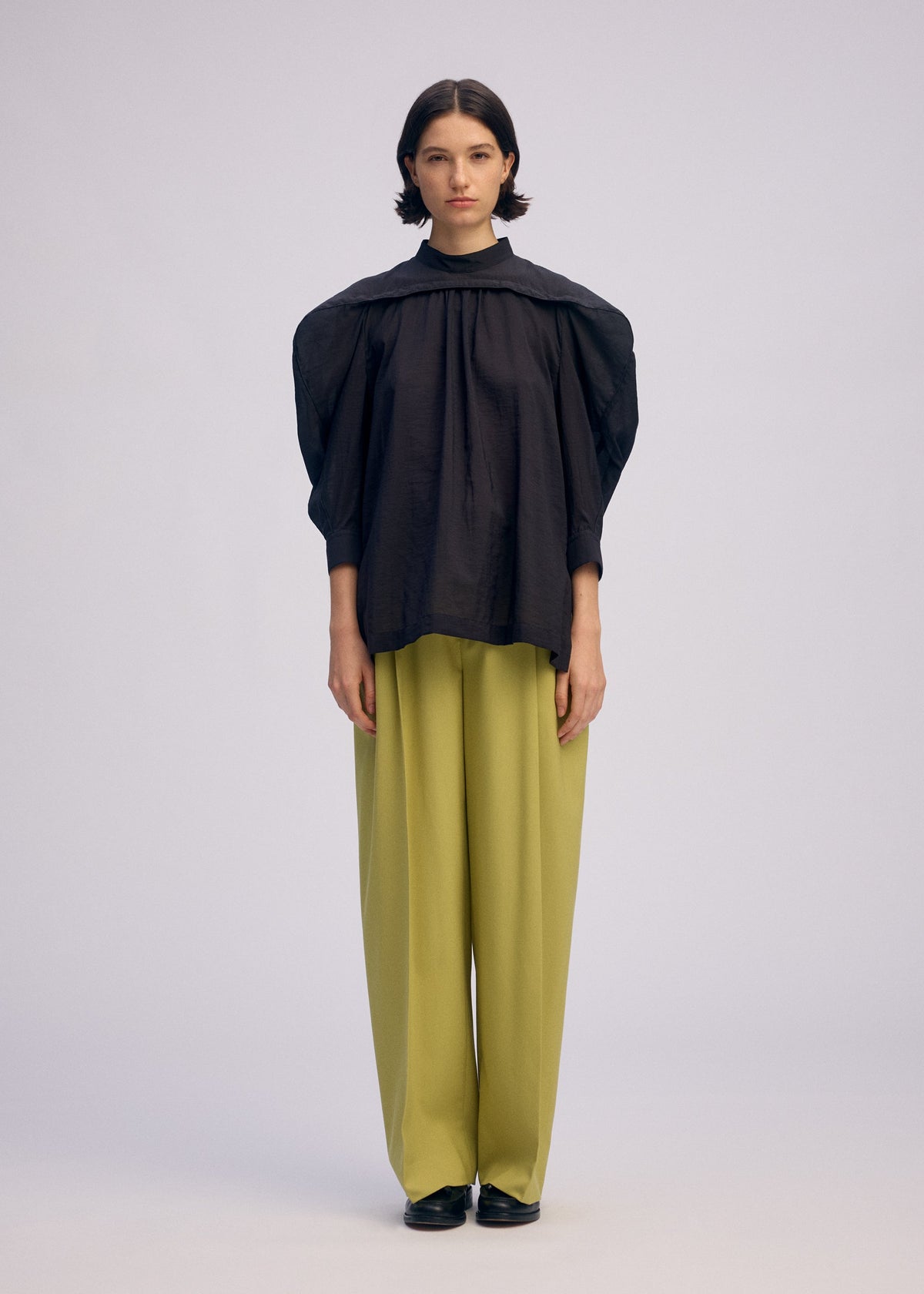 A model wears the Issey Miyake R SHIRT SHEER prêt à porter.