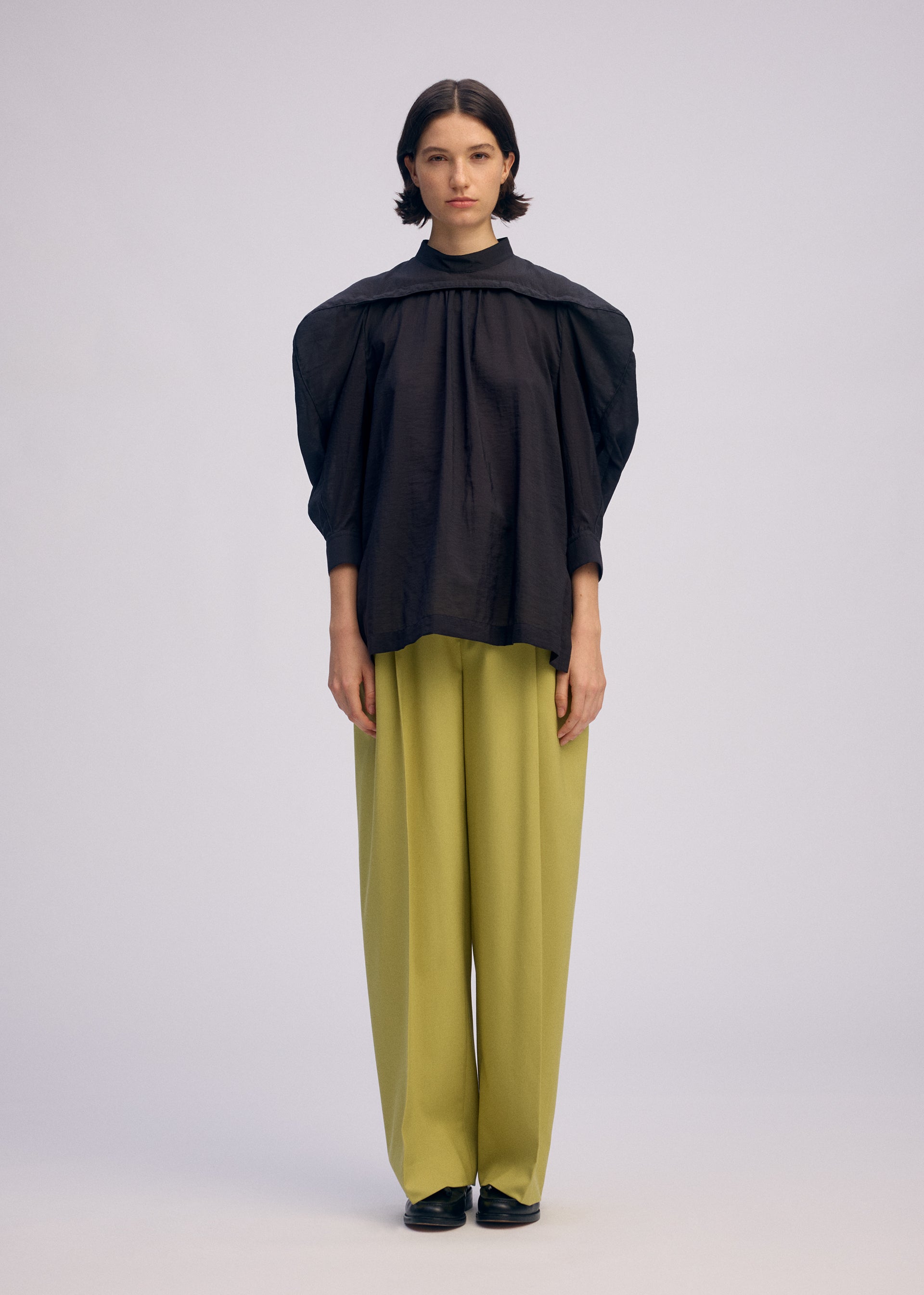A model wears the Issey Miyake R SHIRT SHEER prêt à porter.