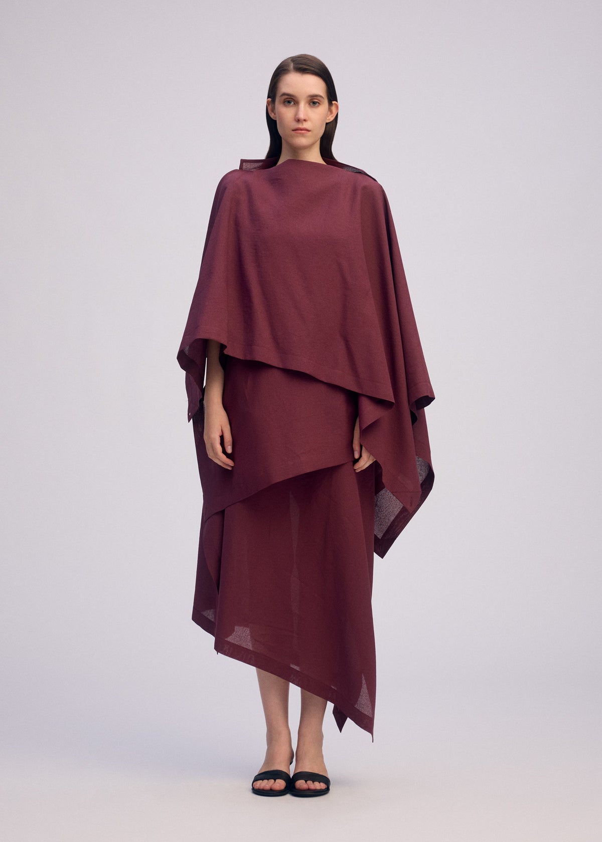 A model wears the ISSEY MIYAKE ALL SQUARES shirt.