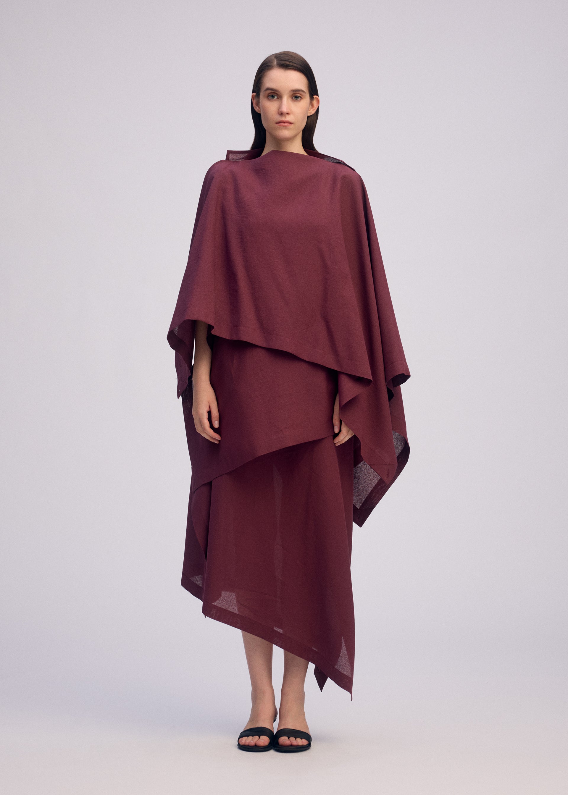 A model wears the ISSEY MIYAKE ALL SQUARES shirt.