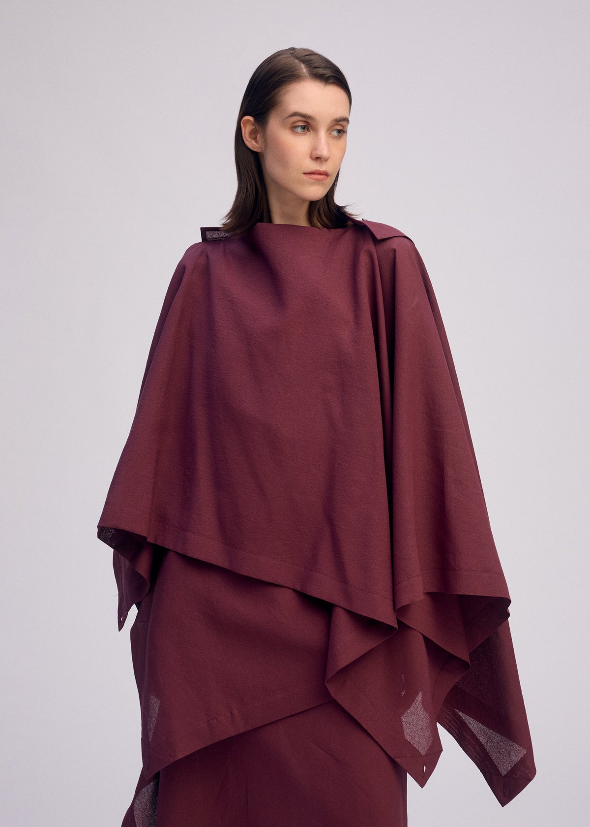 A model wears the ISSEY MIYAKE ALL SQUARES shirt.