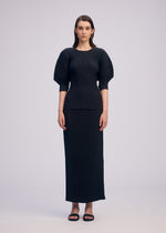 A model wears the ISSEY MIYAKE SLEEK PLEATS sleek-pleats-shirt-burgundy.