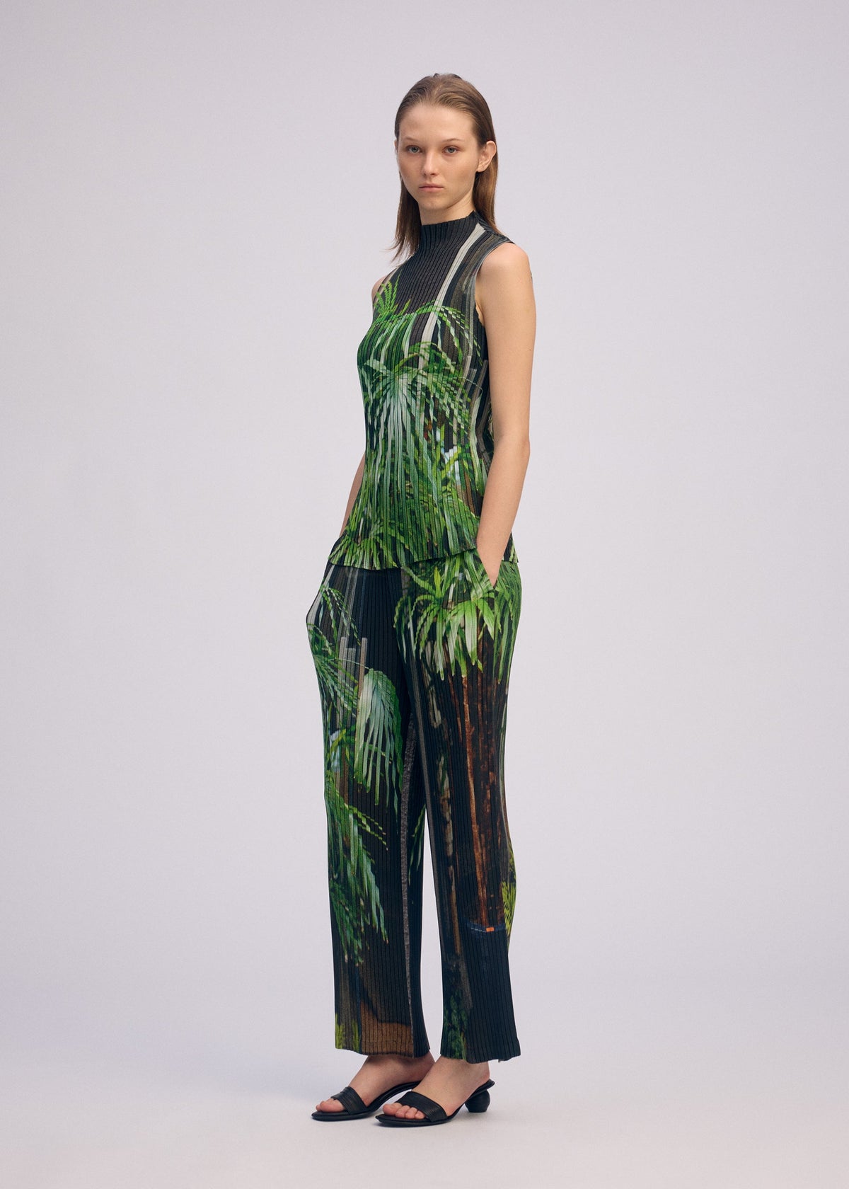 A model wears the Issey Miyake URBAN JUNGLE PLEATS shirt.